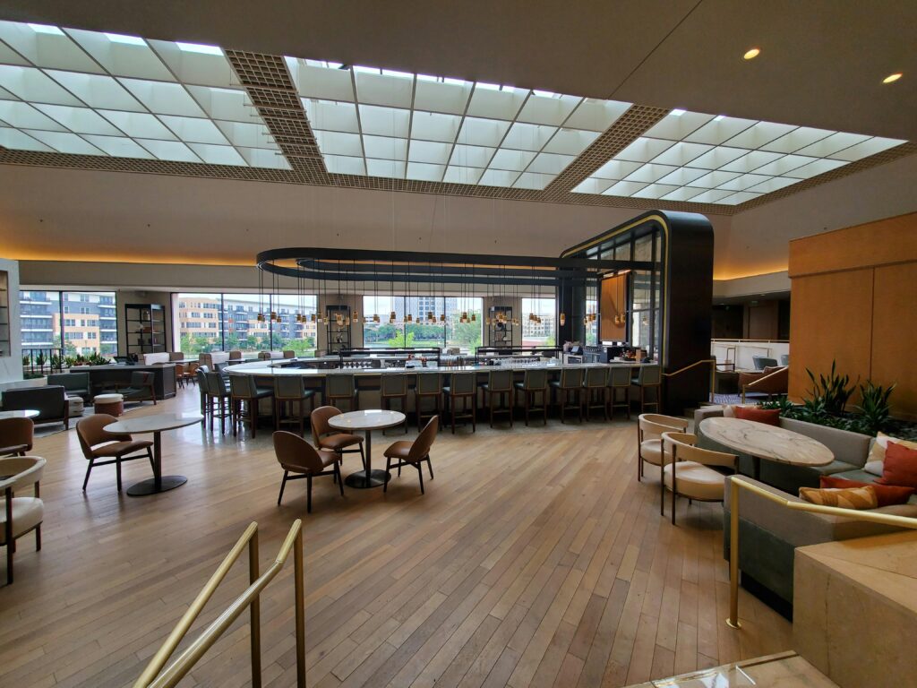 Luxurious and spacious hotel lobby with elegant decor and natural lighting.