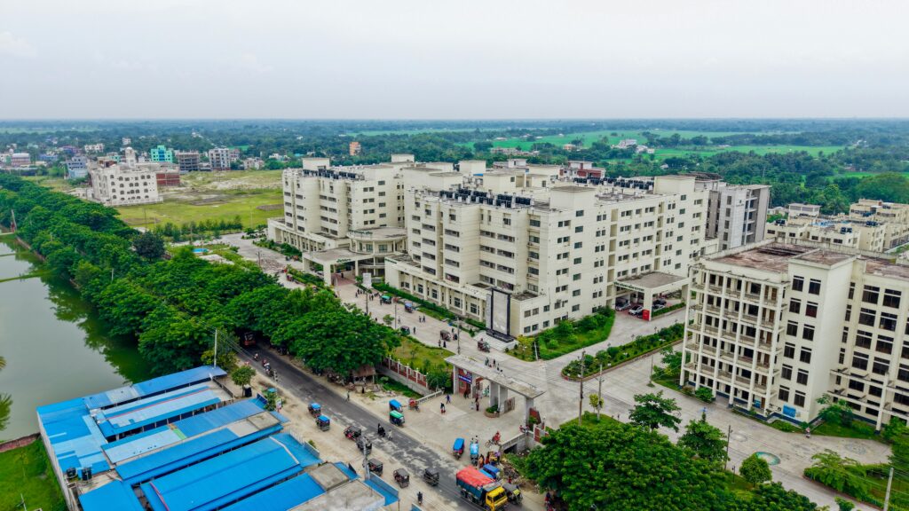 Aerial view of the Kushtia Medical College campus showing modern architecture and lush surroundings.